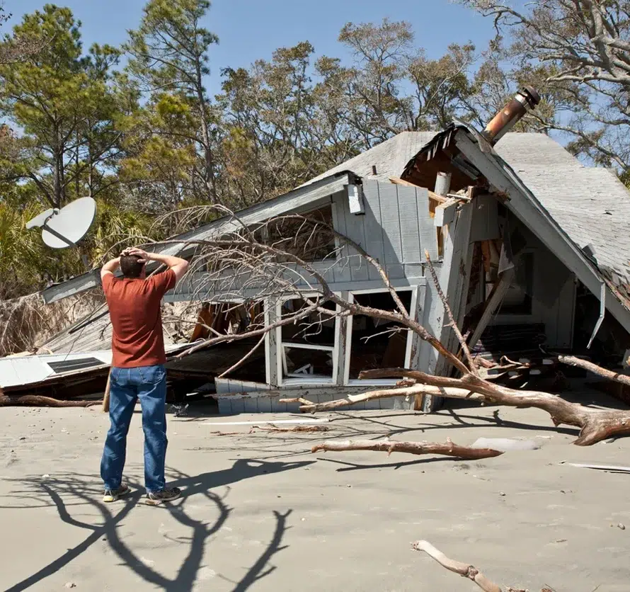 Public-Adjuster-Marketing-Near-Me (1) Homeowner looking at a storm-destroyed house, the property loss moment public adjuster marketing is built around